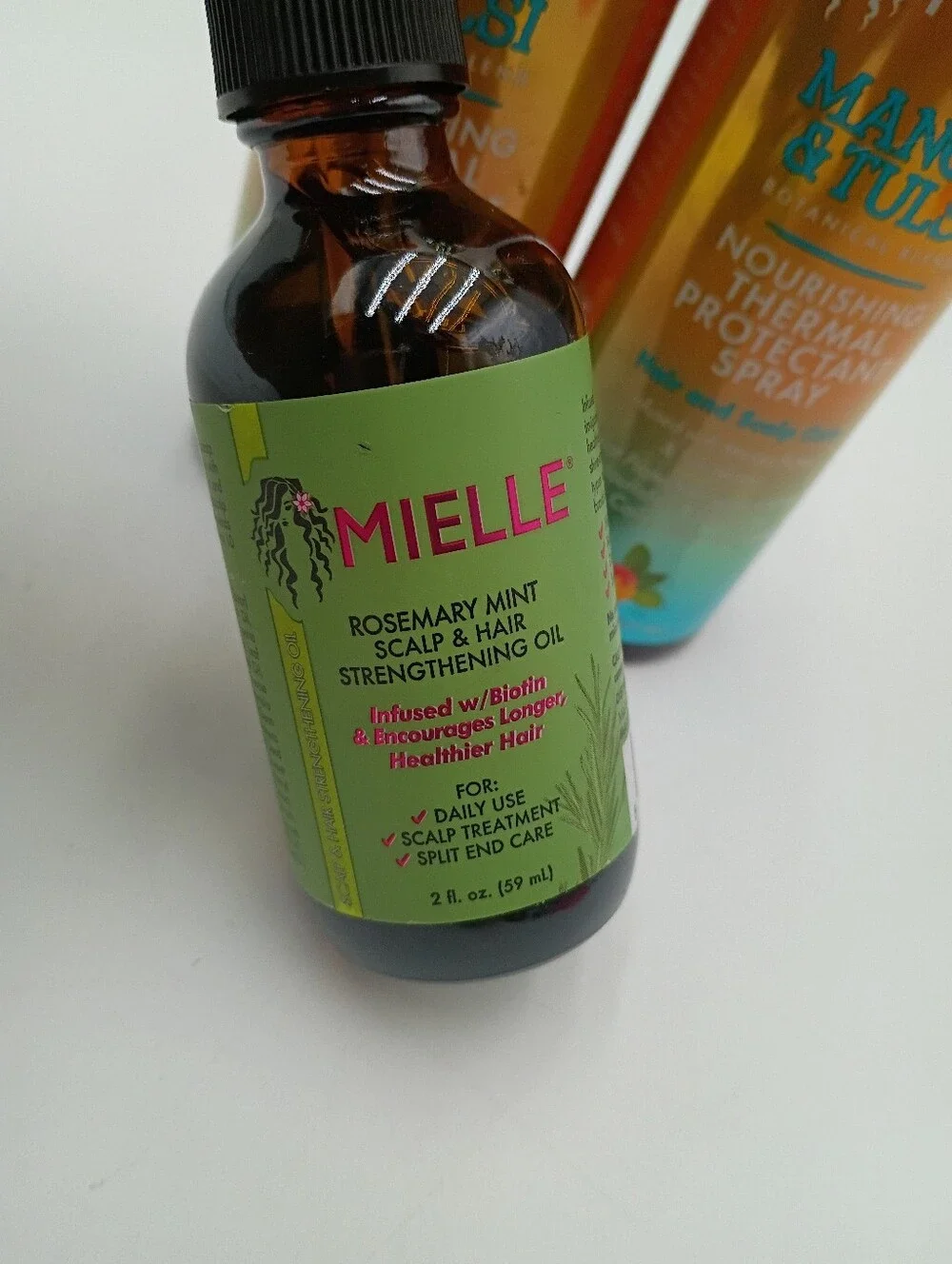 Mielle Haircare Scalp & Hair Strengthening Oil And Thermal Protectant Spray.
